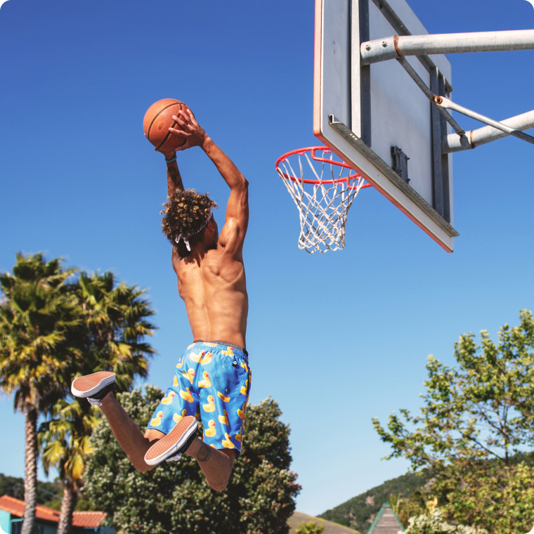 Health Loft dietitians for sports nutrition A man jumping to dunk a basketball