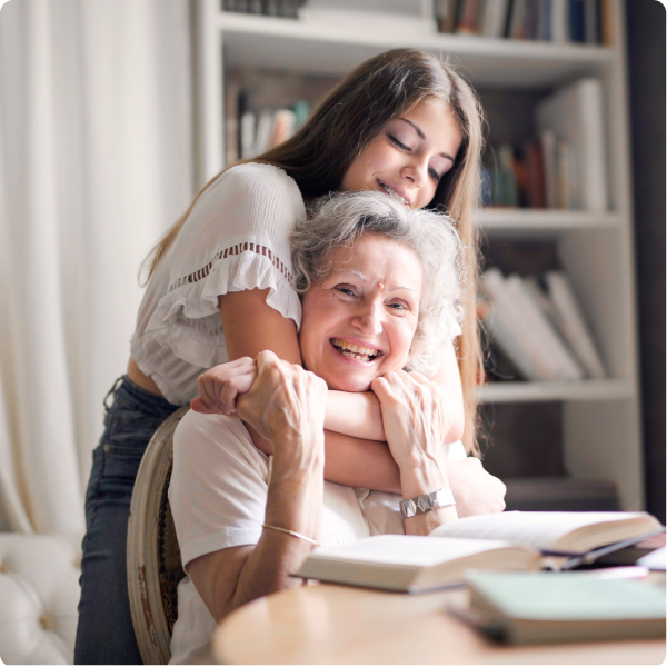 Health Loft dietitians for heart health An elderly woman smiling and reading while her granddaughter hugs her