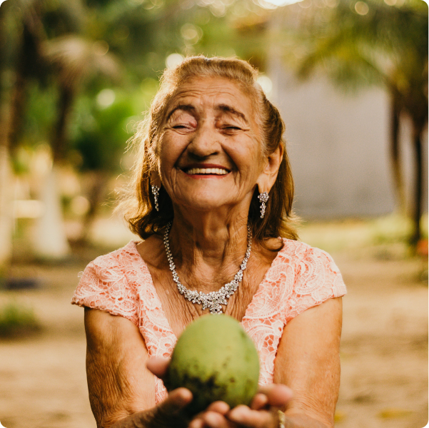 Health Loft dietitians for diabetes nutrition Elderly woman holding a fruit smiling