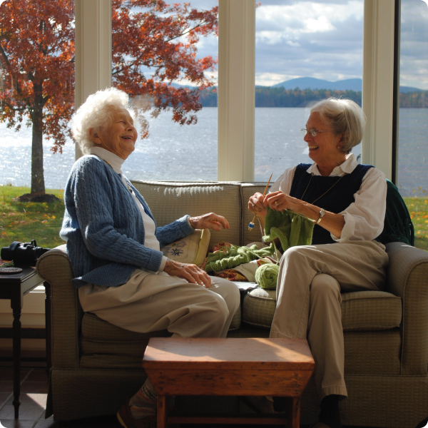 Health Loft dietitians for kidney and liver health Two elderly women knitting in front of a window laughing